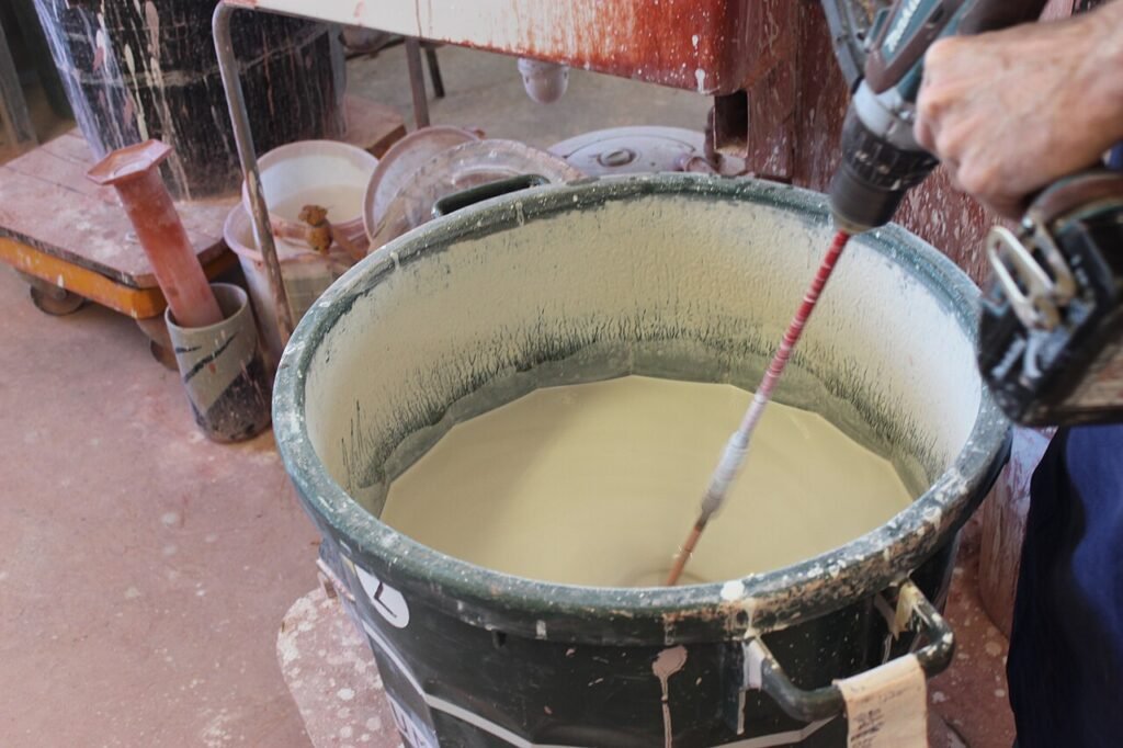 Making and mixing glazes by hand in Taizé pottery workshop