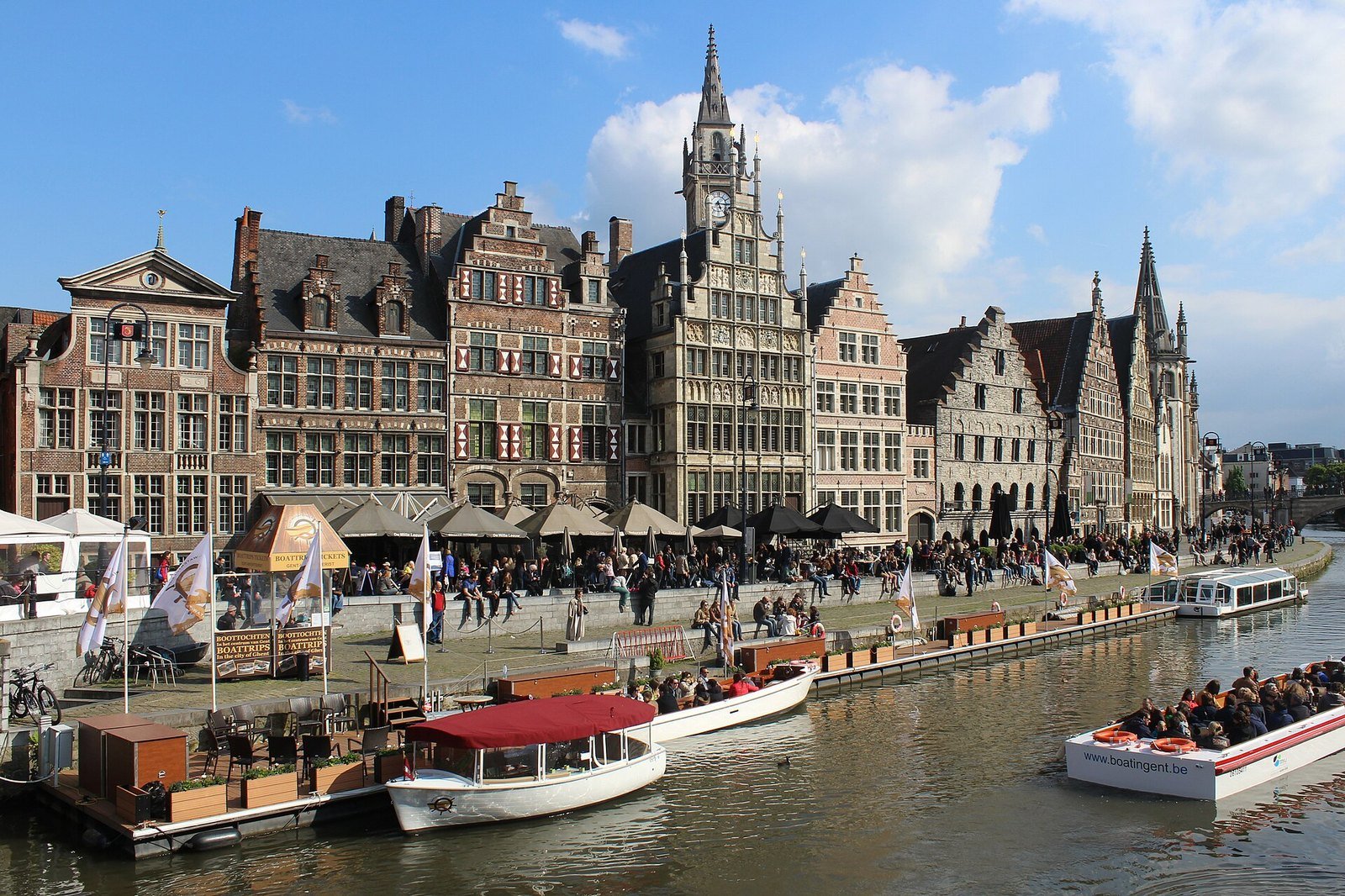 The pale waste-brick wing added for the Design Museum Gent reopening, stepped down beside Ghent's historic rooftops