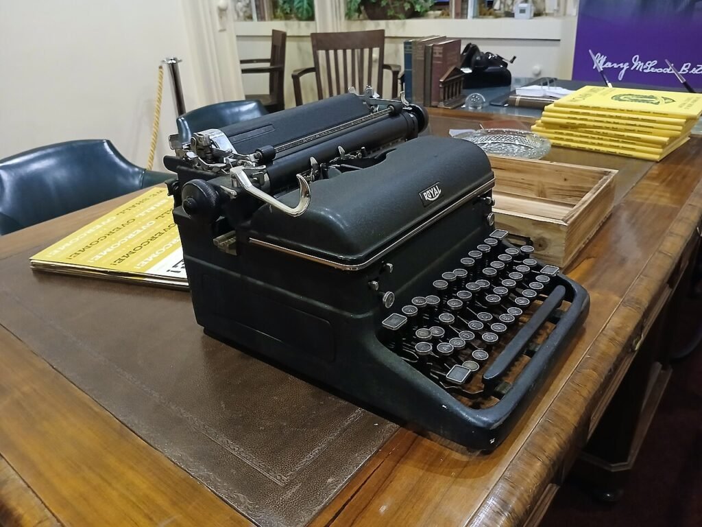 A vintage typewriter on an office desk, evoking the poetry magazine world explored in is Peck & Peck by Bonnie Garmus worth reading