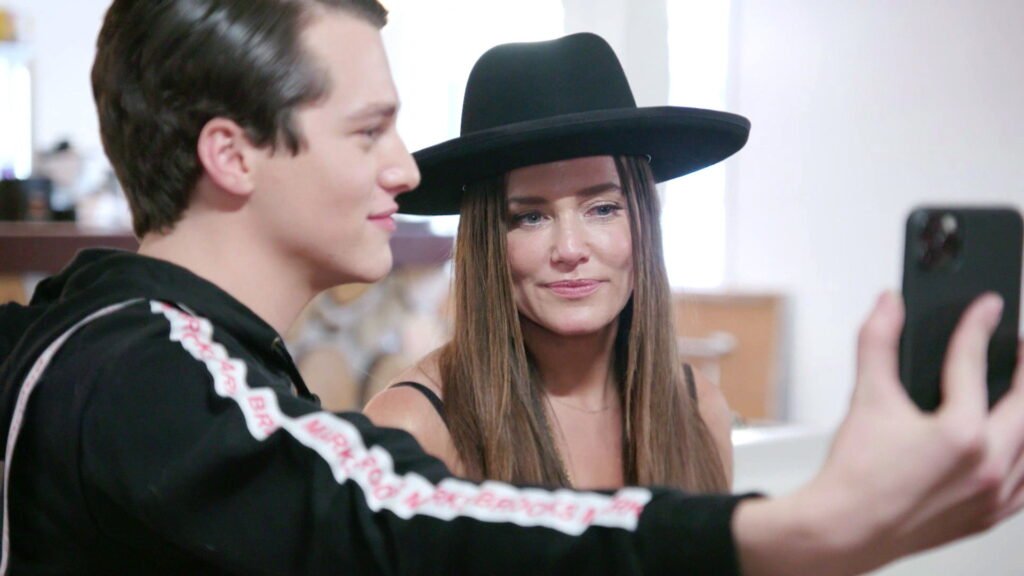 Brooks Marks taking a selfie with his mother Meredith at Park City Fashion Week during The Real Housewives of Salt Lake City season 1 episode 7