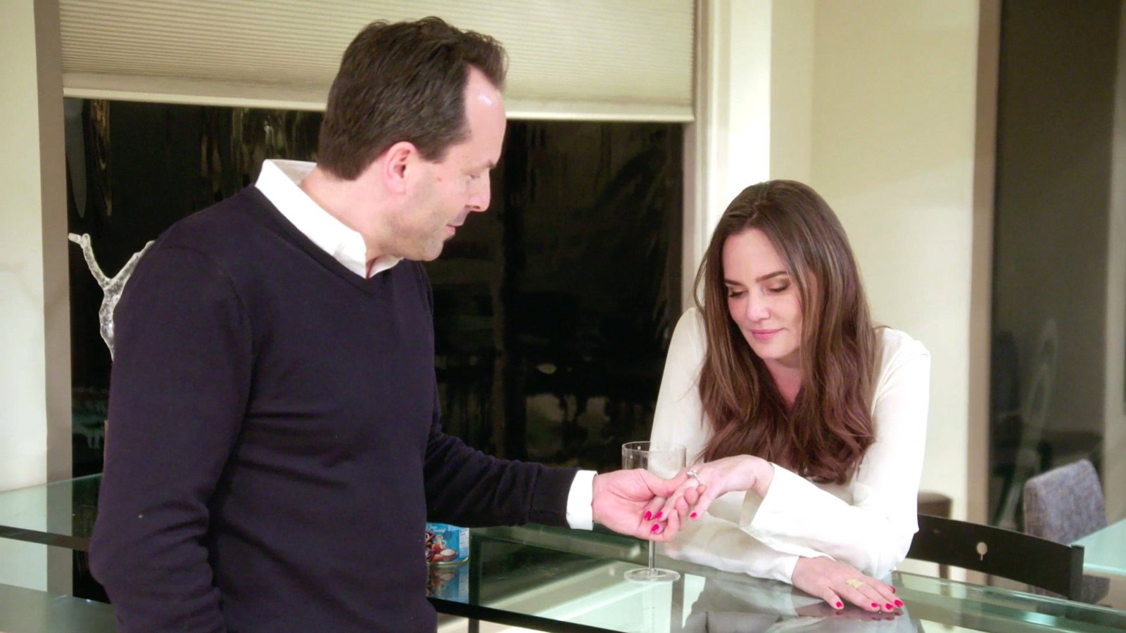 Seth and Meredith Marks holding hands across a table during The Real Housewives of Salt Lake City season 1 episode 9