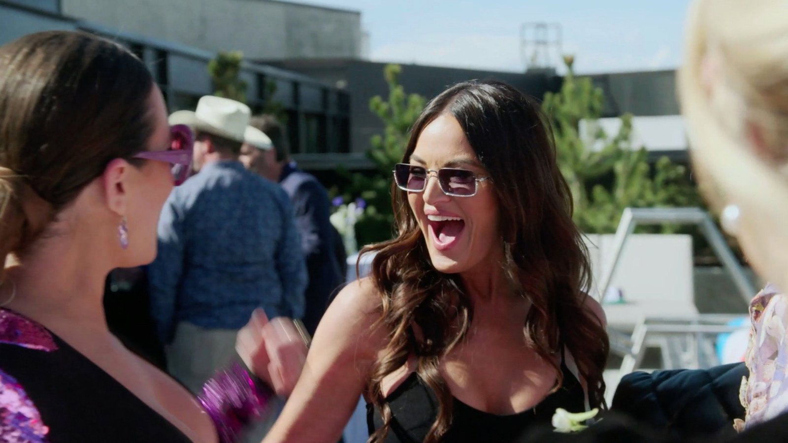 Lisa Barlow laughing in sunglasses outdoors, Meredith Marks at the edge of the frame