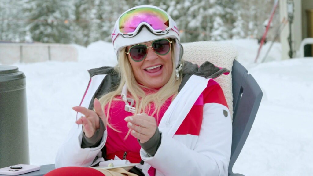 Heather Gay in ski clothing and a helmet, standing outdoors with snow and mountains behind her in The Real Housewives of Salt Lake City