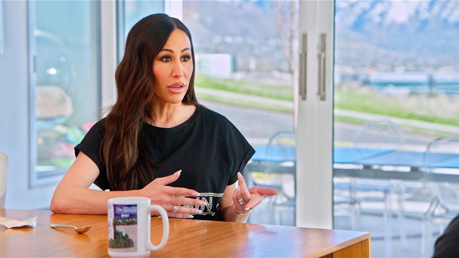 Angie Katsanevas talking at a table