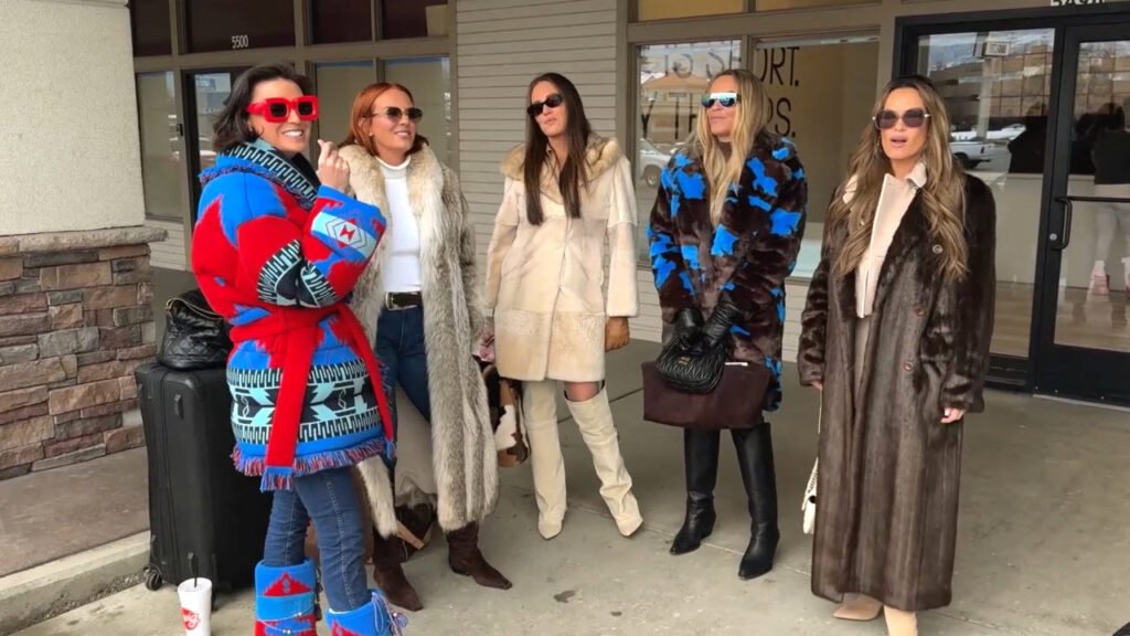 Five of the women in heavy winter coats standing outside a shopfront