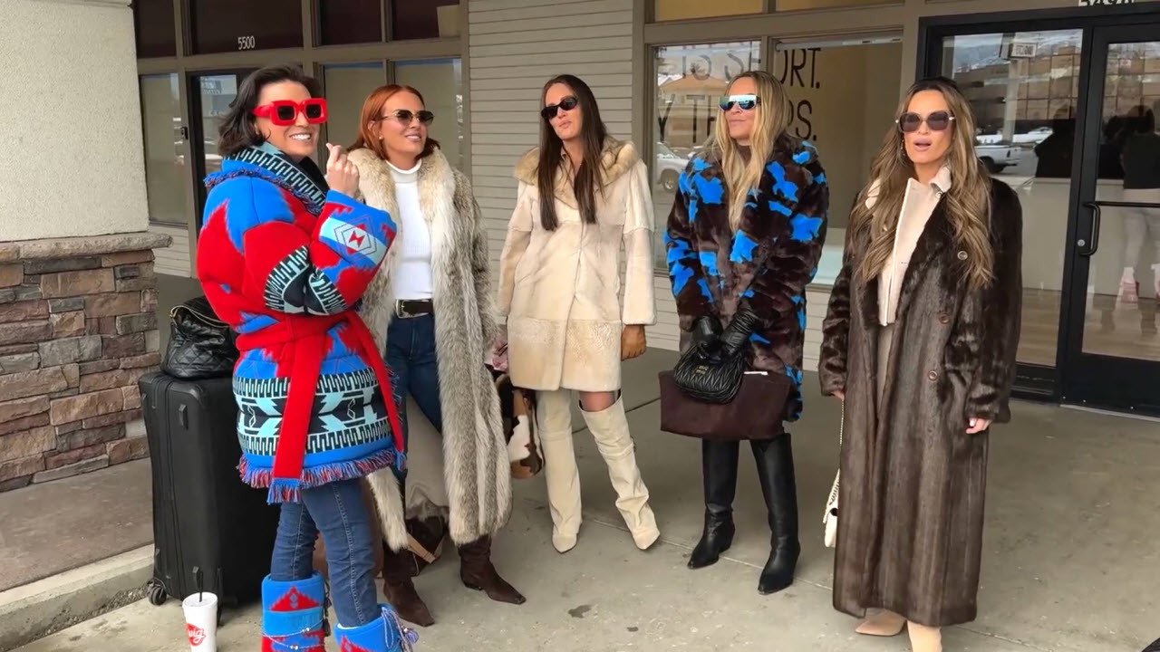 Five of the women in heavy winter coats standing outside a shopfront