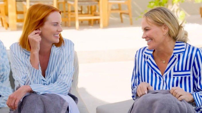 Whitney Rose and Heather Gay talking outdoors in striped pajamas