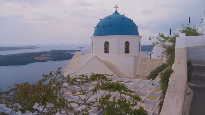 A blue-domed church overlooking the caldera in Santorini
