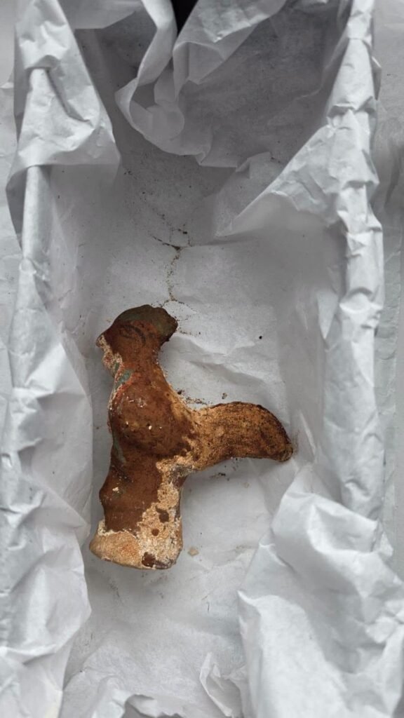 The clay rooster rattle from the Roman child sarcophagus Tomis burial, still holding its rattle pieces after 1,800 years