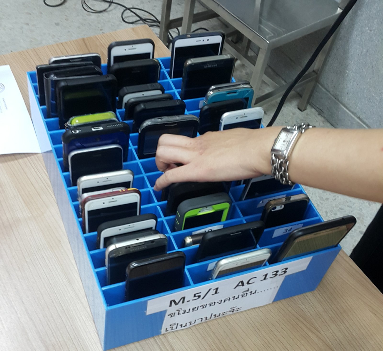 A mobile phone storage cage in a high school, used to keep student phones away during the school day